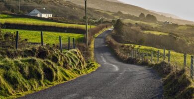 a road through farms in ireland
